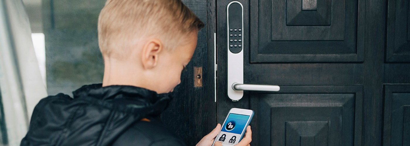 Boy Opening Home with Connected Device protected by Assurant